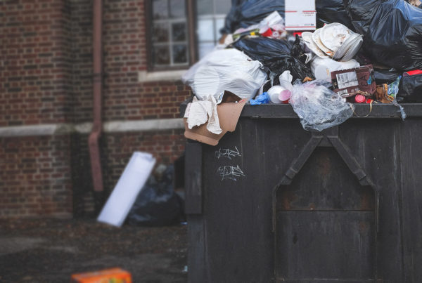 dumpster with overflowing trash