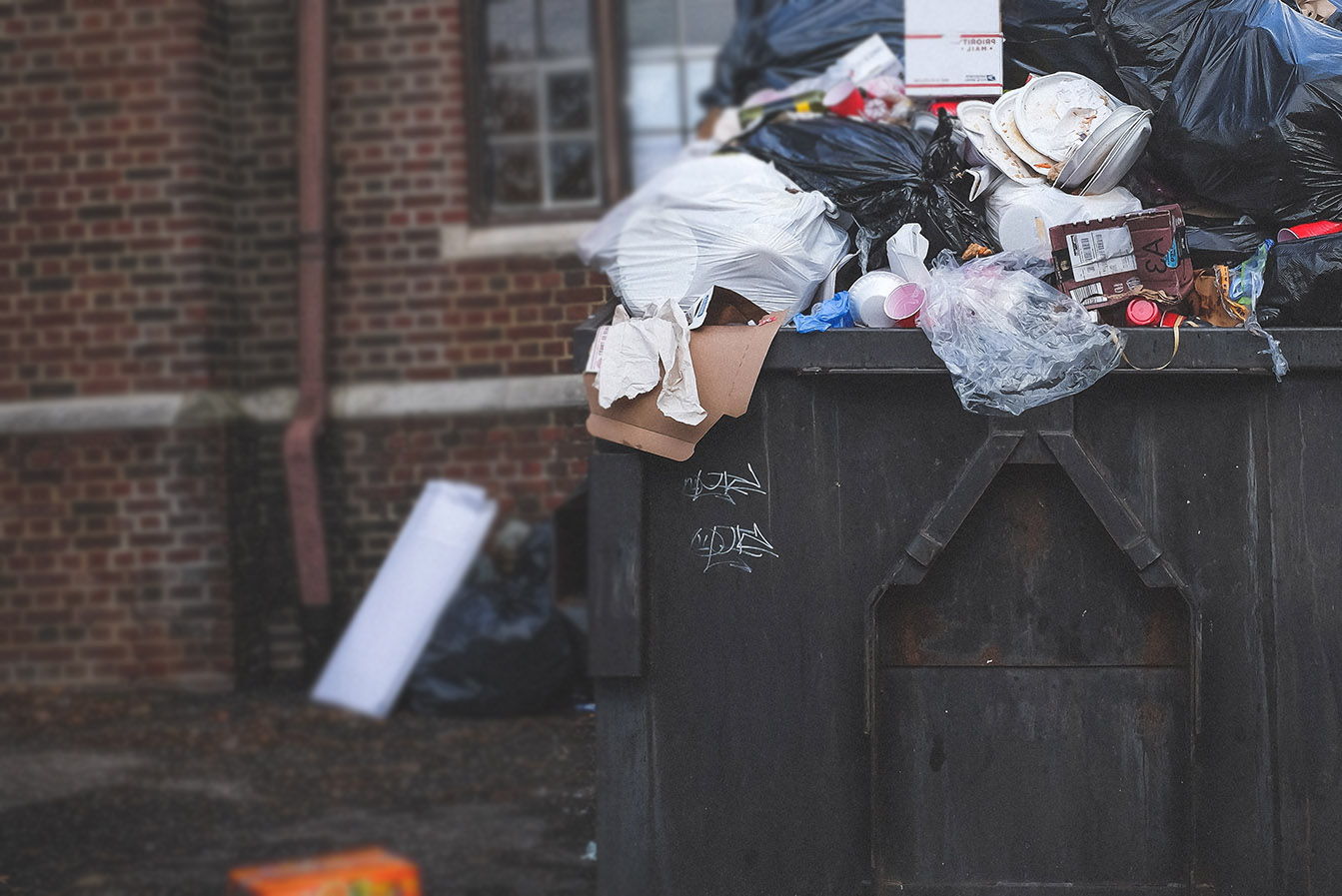 dumpster with overflowing trash
